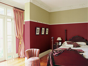 Red and Green Painted Queenslander Bedroom with Wooden Floorboards